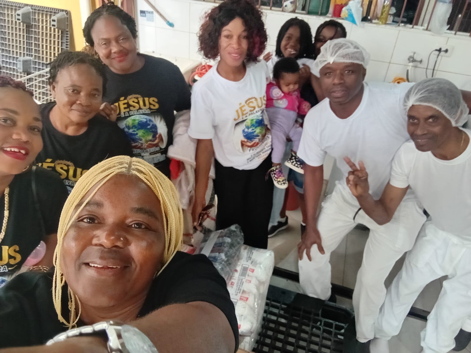 Volunteers and kitchen staff together after preparing meals for the community
