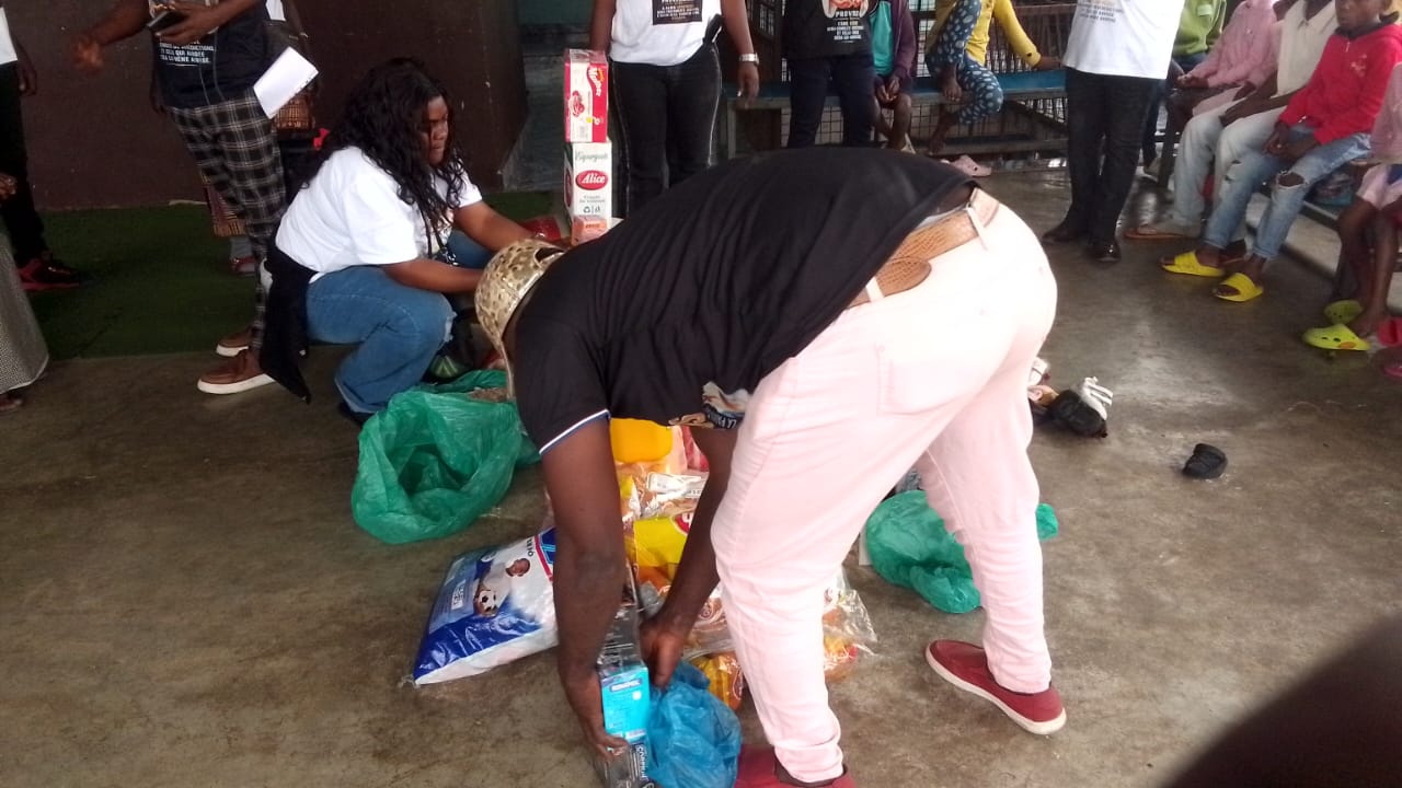 Volunteers unpacking bags of food and household supplies for waiting families