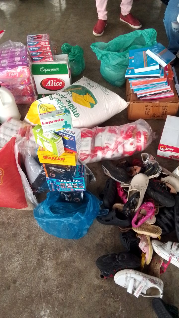 Donated food, medicine, school books and shoes laid out ready for distribution