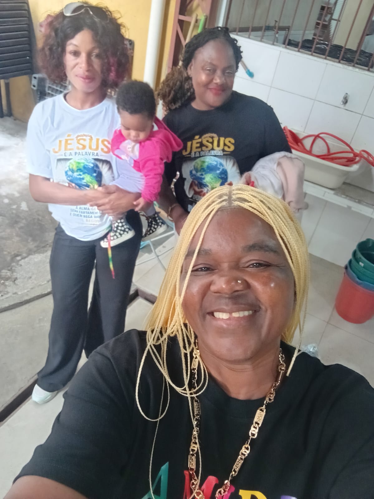 Volunteers holding young children during a community outreach visit