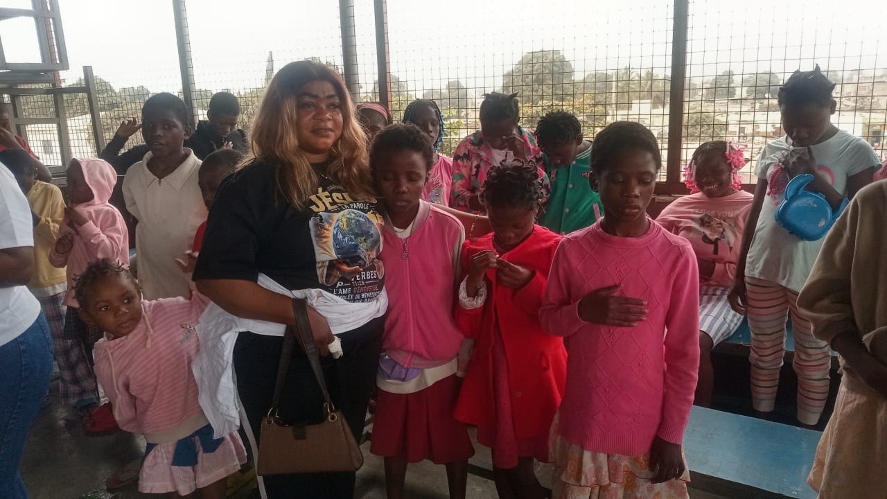 Volunteer with children and babies at a community outreach gathering