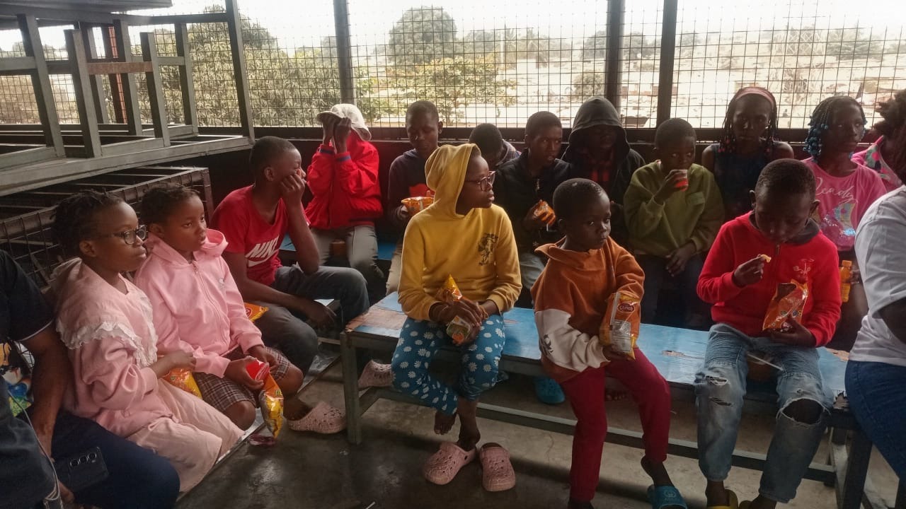 Children and volunteers together during a food and drinks distribution